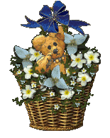 A woven basket full of flowers with a teddy bear peeking out of them.
